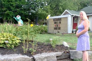 Unhappy Gardener - Trina Wilson at the largest of the garden beds at the Maples. Where there once was a mid-summer feast of colour, there is only mulch and shrub